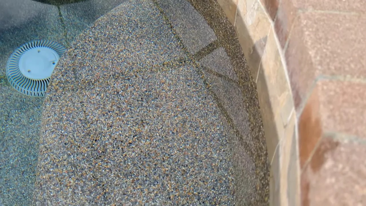 Pebble pool finish showing fine exposed aggregate texture on pool wall and floor
